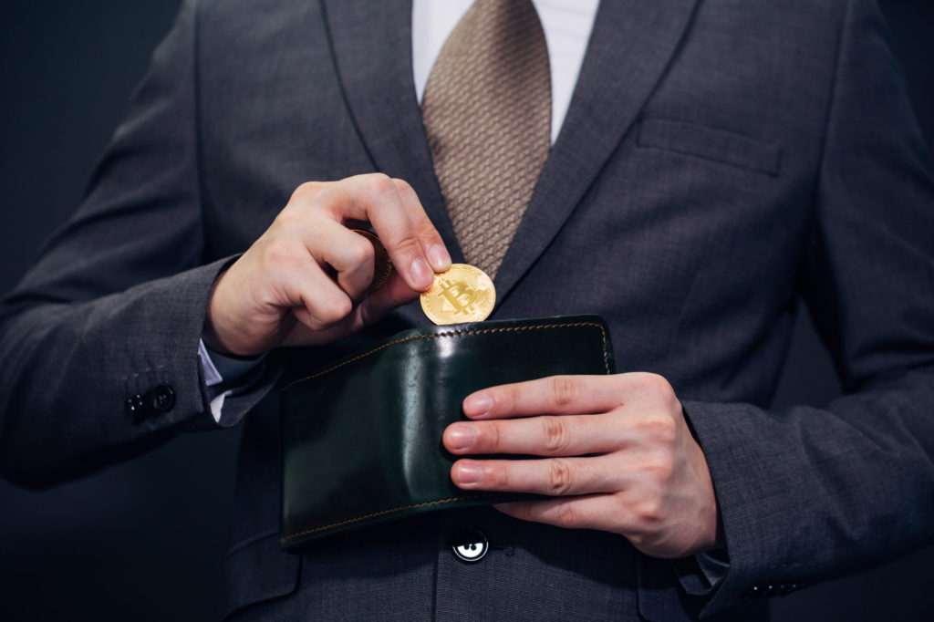 businessman with wallet receiving and paying by bitcoin or cryptocurrency
