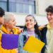 Young students laughing at the university building